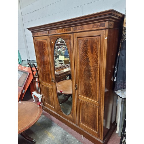 704 - Star Lot: A magnificent antique Edwardian mahogany wardrobe with large beveled oval mirror to centre... 