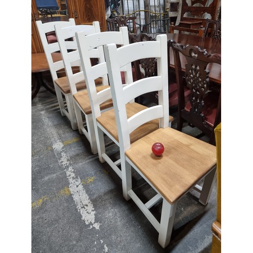 706 - Four charming dining chairs with ladder backs, finished in a fresh white with exposed wood seats. Ni... 