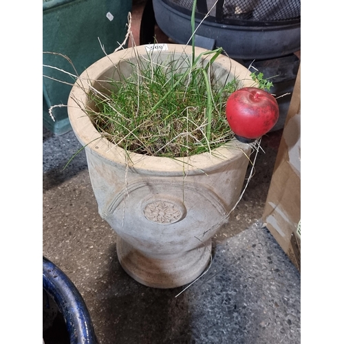 805 - A large terracotta urn shaped garden planter with flower shape design to centre.