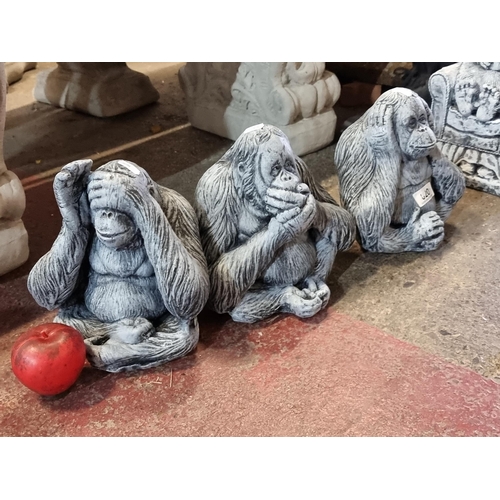 820 - A trio of heavy reconstituted stone garden sculptures in the form of orangutans in the 'hear no evil... 