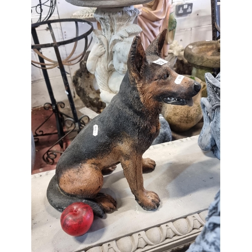 822 - A charming and very heavy reconstituted stone garden sculpture of a german shepherd dog, hand painte... 