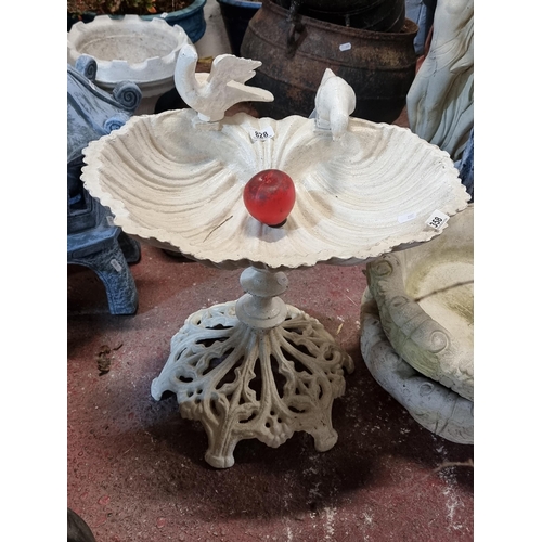 828 - Star Lot : An ethereal heavy cast iron garden bird bath with a basin in the form of a shell, two bir... 