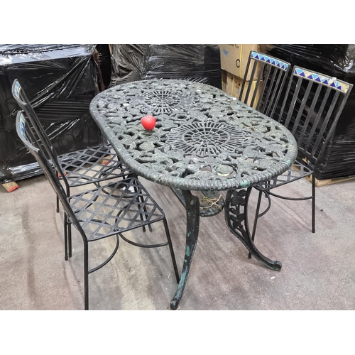 843 - Star Lot : A fabulous five piece vintage heavy cast iron garden table accompanied by a set of four c... 