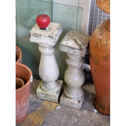 853 - Two elegant reconstituted stone pedestals ideal for planters.