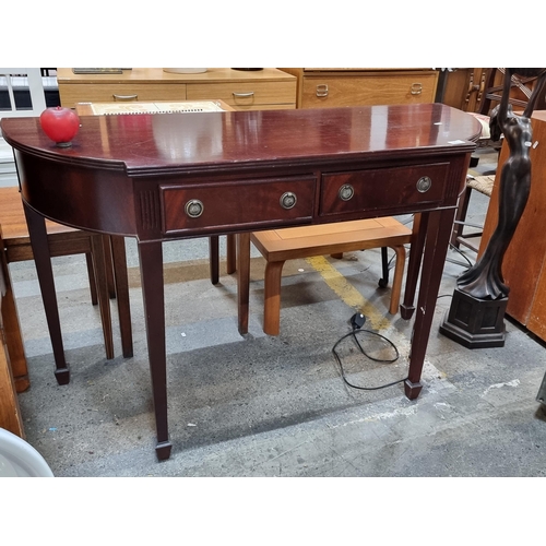 869 - A superb red mahogany console table featuring two pull out drawers to front, tapered legs and metal ... 