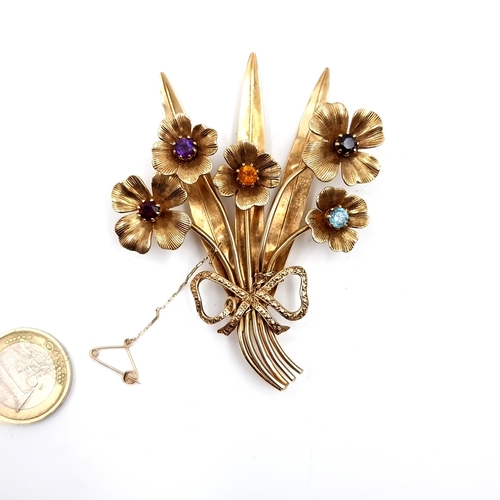 880 - Star Lot : A very fine example of a 9ct Gold floral mounted brooch set with amethyst aqua marine gar... 