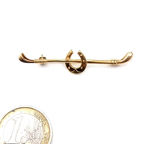 884 - A 9K gold horseshoe brooch with pin intact, weight 1.99 grams.