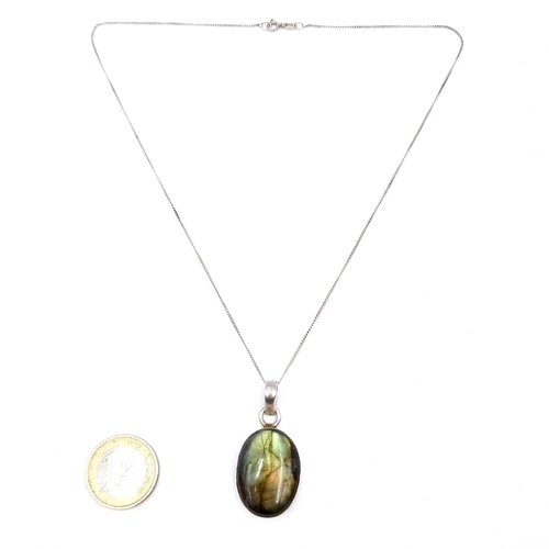 888 - An attractive labradorite pendant stone set with a sterling silver mount and chain, total weight 12.... 