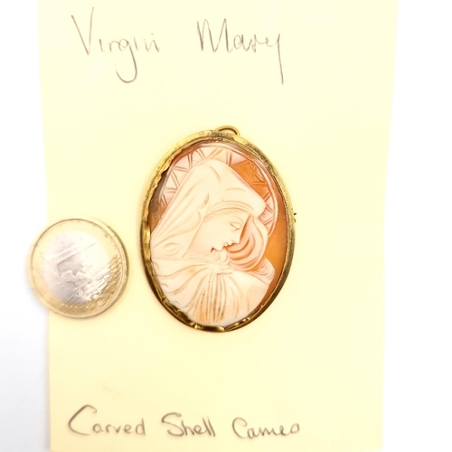 903 - An elegant carved shell cameo brooch/necklace pendant depicting the virgin Mary, pin still intact.