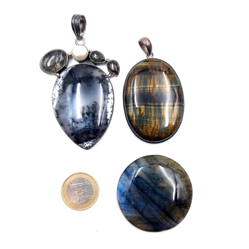 923 - A collection of three stunning polished agate stone items consisting of two pendants one set with dr... 