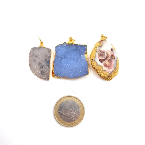 924 - Three drusy gold stone pendants, weighing 5.05 grams, 6.50 grams together with a polished stone exam... 