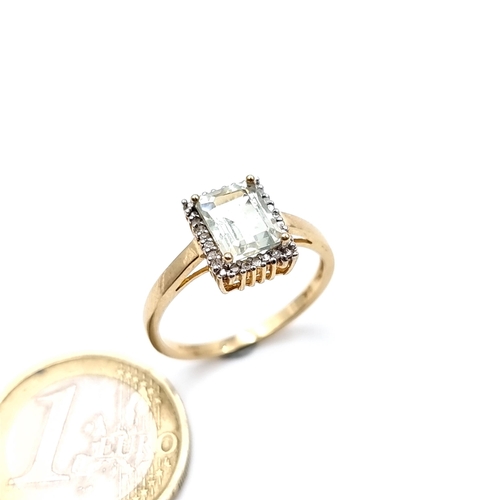 955 - Star Lot : A 9K gold ring with an aqua marine stone and a diamond surround, ring size Q, weight 2.64... 