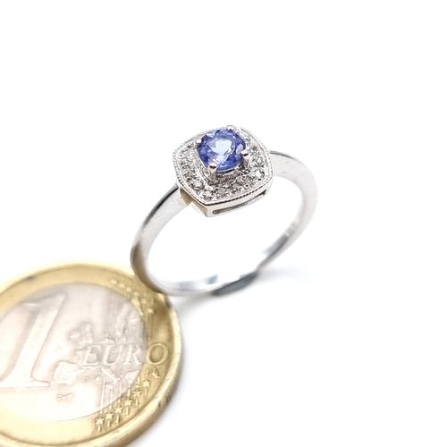 957 - Star Lot : A stunning 9k white gold Tanzanite set ring with a diamond surround, ring size L, weight ... 