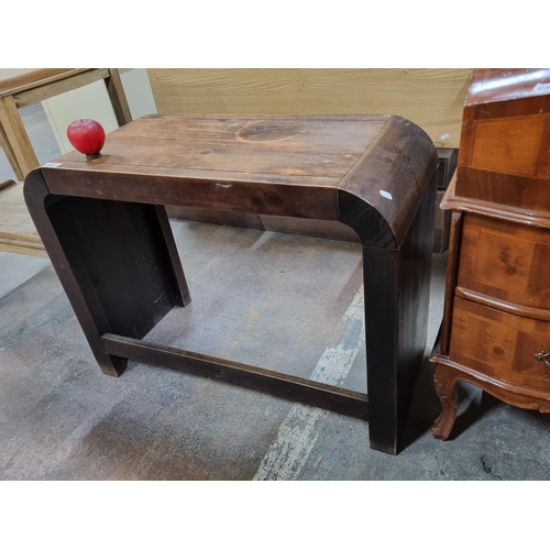 982 - An elegant solid wood console table, crafted from rich walnut wood, featuring a bentwood form showca... 