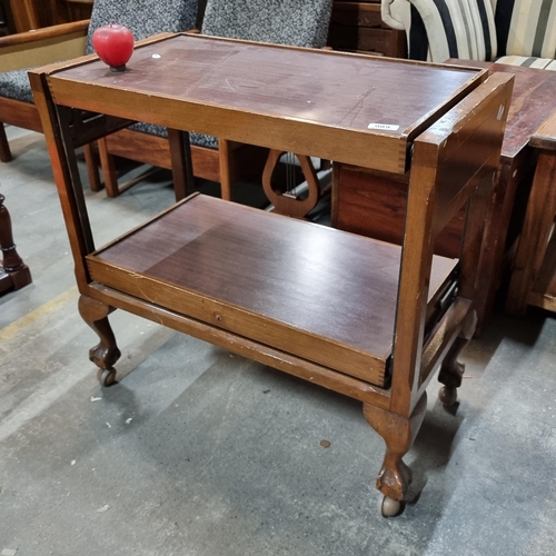 985 - A fabulous 1950's mahogany drinks trolley, featuring graceful ball and claw-feet and castor detailin... 