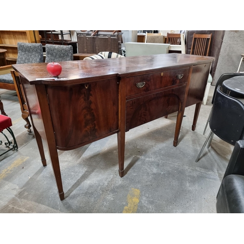 991 - Star Lot : An elegant Sheraton revival flame mahogany sideboard, showcasing exquisite craftsmanship ... 