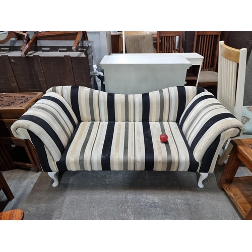 992 - An elegant two-seater sofa with a tactile striped upholstery in shades of cream, grey and black. Boa... 