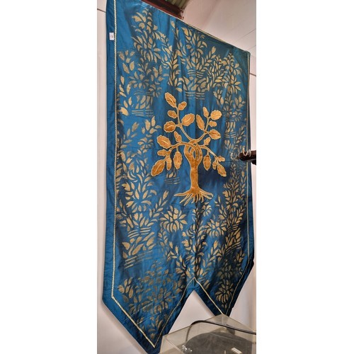 587 - A large heraldic banner with an  tree of life emblem. In shades of golden and turquoise.