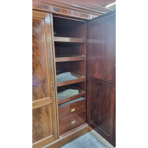 704 - Star Lot: A magnificent antique Edwardian mahogany wardrobe with large beveled oval mirror to centre... 