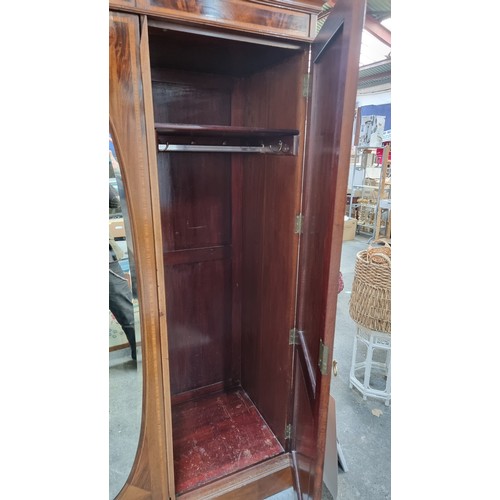 704 - Star Lot: A magnificent antique Edwardian mahogany wardrobe with large beveled oval mirror to centre... 