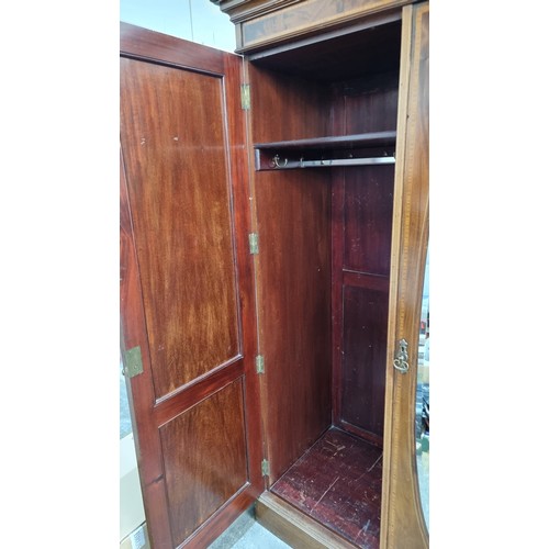 704 - Star Lot: A magnificent antique Edwardian mahogany wardrobe with large beveled oval mirror to centre... 