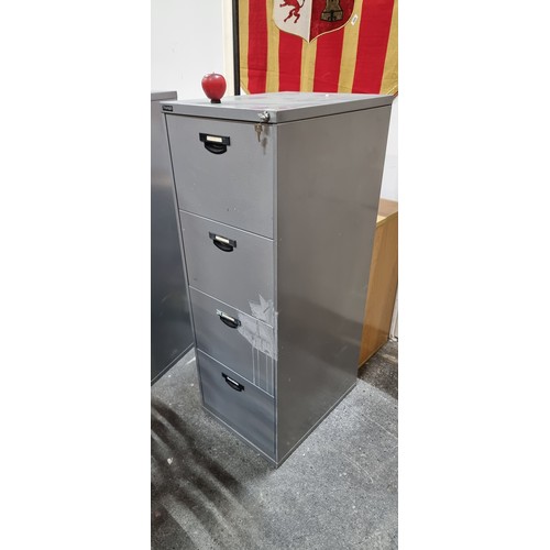 729 - A tall metal filing cabinet by Triumph, with four drawers. Keys intact.