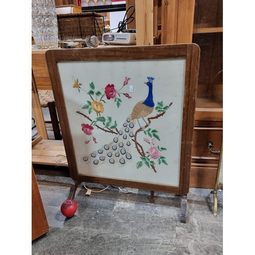 874 - A charming vintage fire screen featuring a beautiful embroidered peacock to front. Folds out to beco... 