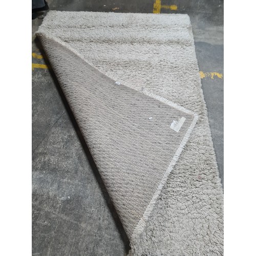 720 - A fabulous beige shaggy rug. L230cm x W165cm