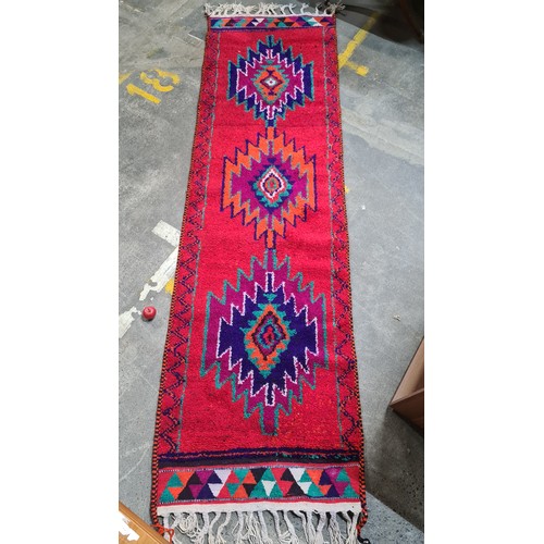 972 - Star Lot : A vibrant hand knotted Aztec style hall runner rug in shades of red, blue, orange, purple... 