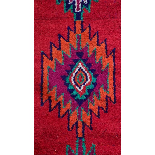 972 - Star Lot : A vibrant hand knotted Aztec style hall runner rug in shades of red, blue, orange, purple... 