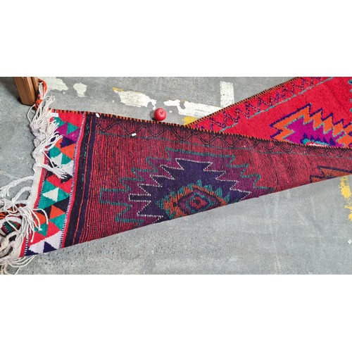 972 - Star Lot : A vibrant hand knotted Aztec style hall runner rug in shades of red, blue, orange, purple... 