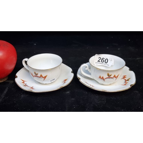 260 - A striking pair of Meissen coffee cups featuring a fabulous Art Deco style geometric motif with gilt... 