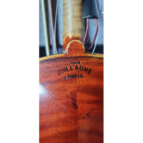 776 - An antique violin with label stating Vuillaume of Paris with carved wood elements, bow and leather t... 