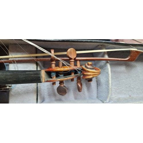 776 - An antique violin with label stating Vuillaume of Paris with carved wood elements, bow and leather t... 