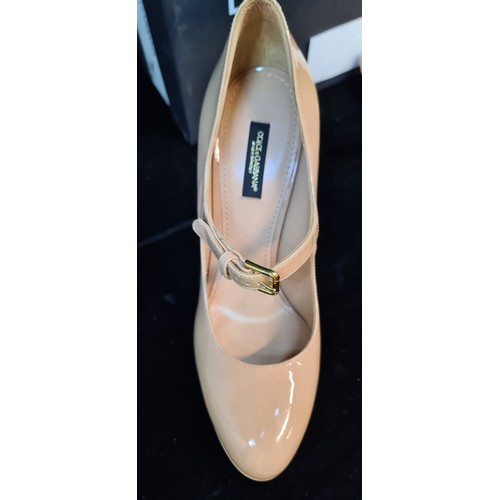 228 - Star Lot: A timeless pair of Dolce & Gabbana genuine leather platform heels in a glossy beige finish... 