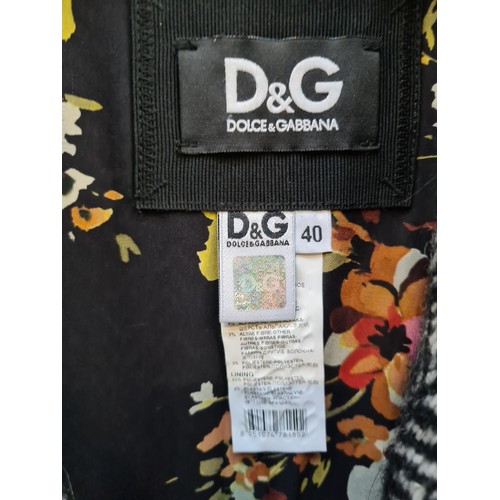 235 - Star Lot - A fabulous ladies Dolce & Gabbana coat finished with wool blend herringbone motif fabric,... 