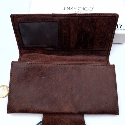 517 - A designer as new boxed Jimmy Choo leather wallet, featuring lovely belt detail and interior compart... 