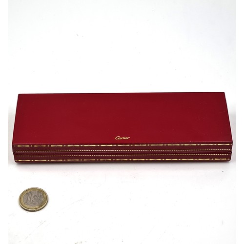 560 - Star Lot : A must de Cartier Paris trinity fountain pen set with a red bodied finish with gold metal... 