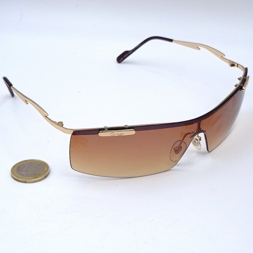 567 - Star Lot : A pair of Cartier wrap round single sunglasses with Cartier marked frame, model number CO... 