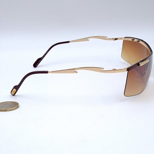 567 - Star Lot : A pair of Cartier wrap round single sunglasses with Cartier marked frame, model number CO... 