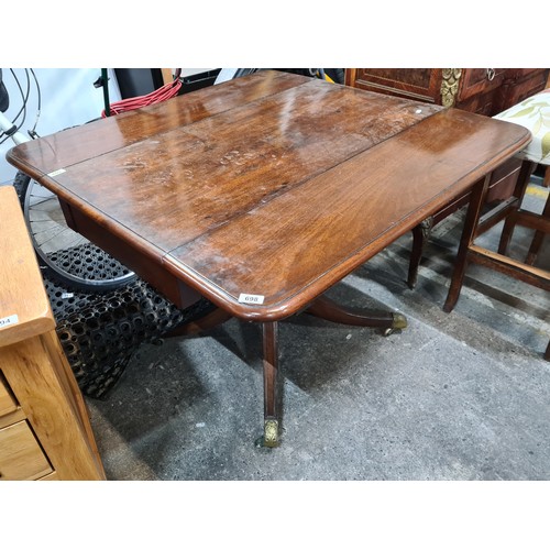 698 - Star Lot: A very handsome Edwardian drop leaf mahogany table held on a central pedestal ending in fo... 