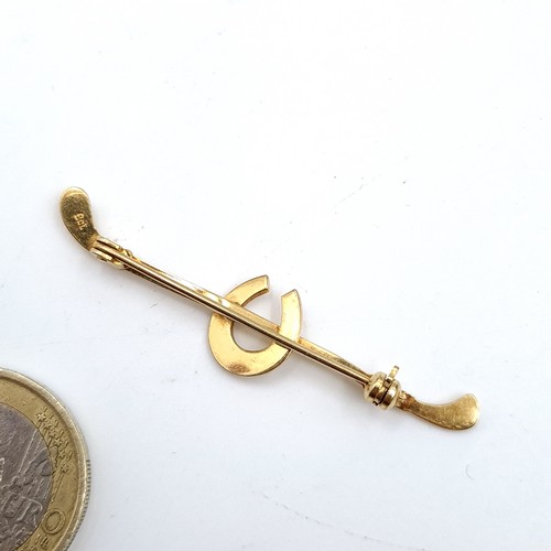 884 - A 9K gold horseshoe brooch with pin intact, weight 1.99 grams.