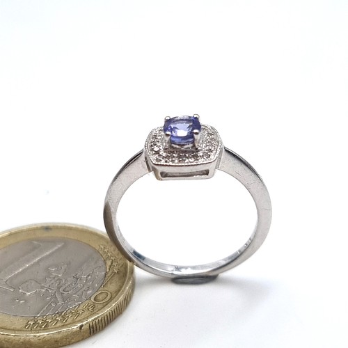 957 - Star Lot : A stunning 9k white gold Tanzanite set ring with a diamond surround, ring size L, weight ... 