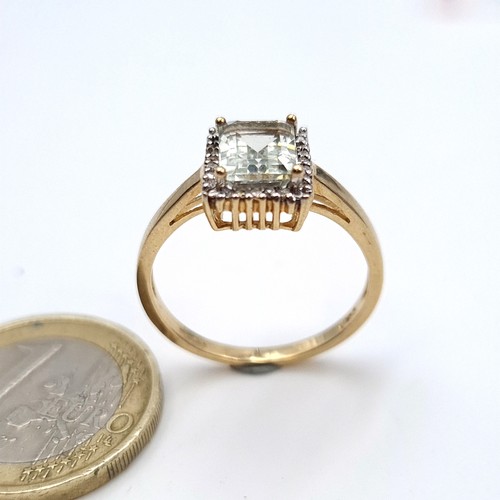 955 - Star Lot : A 9K gold ring with an aqua marine stone and a diamond surround, ring size Q, weight 2.64... 