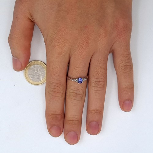 960 - A fabulous 9k white gold ring featuring a lovely tanzanite to centre with white sapphire shoulders, ... 