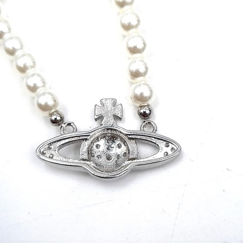 964 - A stunning pearl necklace by Vivienne Westwood featuring a gem set emblem pendant with presentation ... 