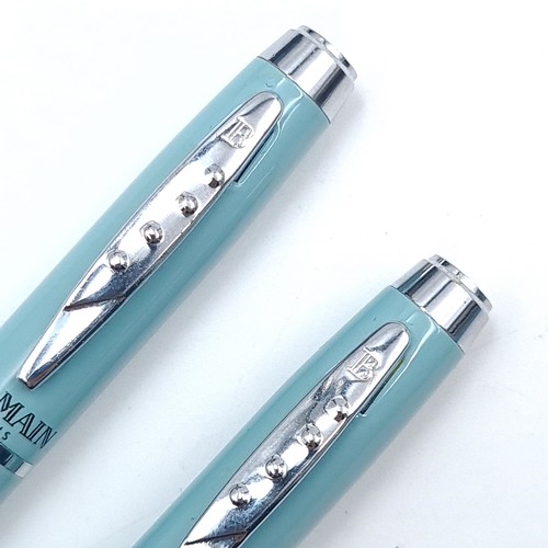 558 - Star Lot : A writing set by Balmain Paris consisting of a Fountain pen and biro with turquoise body ... 