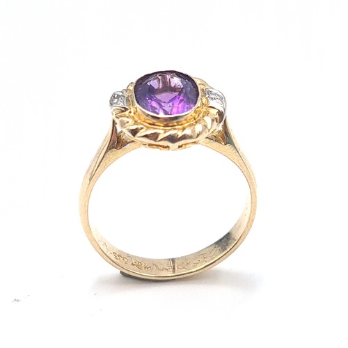 559 - Star Lot : An outstanding 14K gold stamped to band amethyst and diamond ring with scroll relief moun... 