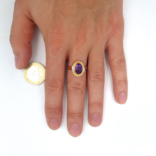 559 - Star Lot : An outstanding 14K gold stamped to band amethyst and diamond ring with scroll relief moun... 