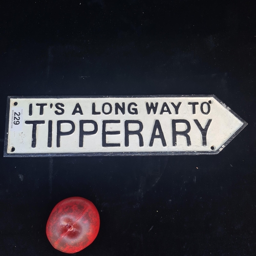 229 - A cast metal plaque directing towards Co. Tipperary.